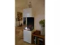 Elegant and tall freestanding fireplace in white with three glass panels